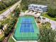 Aerial view of a tennis court near townhouses and the main road at 10411 Coral Landings Ln # 85, Placida, FL 33946