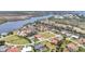 Wide aerial shot of a residential neighborhood with a river and green spaces nearby at 11 Amberjack Ln, Placida, FL 33946