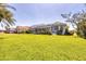Backyard showcasing a screened lanai and lush landscaping at 11 Amberjack Ln, Placida, FL 33946