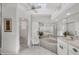Bright bathroom features a soaking tub, double vanity, tiled floors, and a walk-in shower at 11 Amberjack Ln, Placida, FL 33946