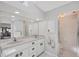 Neutral bathroom features a double vanity with marble countertops and a walk-in shower at 11 Amberjack Ln, Placida, FL 33946