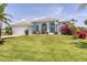A well maintained, single-story home with large arched windows, landscaping, and grass at 11 Amberjack Ln, Placida, FL 33946