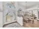 View of a home's foyer with glass paneled front door, hardwood floors, and a glass dining set at 11 Amberjack Ln, Placida, FL 33946