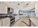Bright kitchen features white cabinets, stainless steel appliances, and a tiled backsplash at 11 Amberjack Ln, Placida, FL 33946