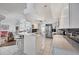 Bright open-concept kitchen with stainless steel appliances and adjacent breakfast bar at 11 Amberjack Ln, Placida, FL 33946