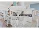 Modern kitchen with white cabinetry, bar seating, and open design at 11 Amberjack Ln, Placida, FL 33946