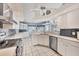 Bright kitchen features white cabinets, stainless steel appliances, and a tiled backsplash at 11 Amberjack Ln, Placida, FL 33946