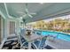 Enclosed lanai featuring outdoor dining and view of the pool and lush landscaping at 11 Amberjack Ln, Placida, FL 33946