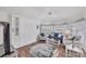 Bright, coastal-themed living room with a Murphy bed, comfortable seating, and hardwood floors at 11 Amberjack Ln, Placida, FL 33946