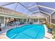 Beautiful screened pool with ample deck space and views of the house and backyard at 11 Amberjack Ln, Placida, FL 33946