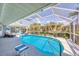Well-maintained pool with screened enclosure, and patio area for relaxation and recreation at 11 Amberjack Ln, Placida, FL 33946