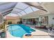 Large screened pool with patio, lounge chairs, and backyard views at 11 Amberjack Ln, Placida, FL 33946