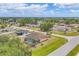 Scenic aerial view of a home featuring a screened-in pool, surrounded by lush landscaping and greenery at 11008 Waterford Ave, Englewood, FL 34224