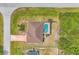 Aerial view of the home showing the pool, roof, driveway, and surrounding yard and landscaping at 11008 Waterford Ave, Englewood, FL 34224