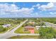 Wide aerial shot displaying the house nestled in a calm neighborhood surrounded by lush greenery at 11008 Waterford Ave, Englewood, FL 34224