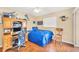 Sports-themed bedroom with a desk, wooden floors, decorated with Kentucky Wildcats memorabilia, and natural light at 11008 Waterford Ave, Englewood, FL 34224