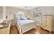 Bright bedroom with white furniture, hardwood floors, decorated with starfish-themed decor, and natural light at 11008 Waterford Ave, Englewood, FL 34224