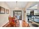 Cozy dining area with hardwood floors and sliding glass doors to the pool area, and a modern chandelier at 11008 Waterford Ave, Englewood, FL 34224