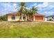 Lovely single-story home with palm trees, warm exterior tones, and a meticulously kept green lawn at 11008 Waterford Ave, Englewood, FL 34224