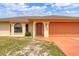 Close up exterior featuring a well maintained lawn, stucco construction, a terracotta driveway and arched windows at 11008 Waterford Ave, Englewood, FL 34224
