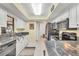 Updated kitchen with stainless steel appliances, granite countertops, white cabinets, and modern fixtures at 11008 Waterford Ave, Englewood, FL 34224