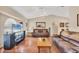 Cozy living room with hardwood floors, comfortable leather sofas, and bright, airy lighting at 11008 Waterford Ave, Englewood, FL 34224