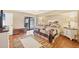 Bright main bedroom with wood floors, ensuite access, and sliding door to the lanai and pool at 11008 Waterford Ave, Englewood, FL 34224