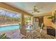 View of screened patio with an outdoor dining area overlooking the sparkling pool at 11008 Waterford Ave, Englewood, FL 34224