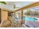 Screened patio with an outdoor dining area with beautiful views of the swimming pool at 11008 Waterford Ave, Englewood, FL 34224