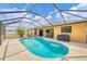Screened swimming pool, outdoor grill, outdoor seating and dining under a covered lanai at 11008 Waterford Ave, Englewood, FL 34224