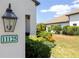 Exterior shot of the home's address number and a well-maintained landscaped yard at 11125 Mcdermott Ct, Englewood, FL 34223