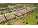 Aerial view of neighborhood featuring tile roofs, mature landscaping, and community ponds at 11125 Mcdermott Ct, Englewood, FL 34223