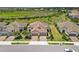 Aerial view of meticulously landscaped homes showcasing the tile roofs and well-manicured lawns at 11125 Mcdermott Ct, Englewood, FL 34223