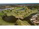 Aerial view of the lush golf course with a beautiful winding lake and meticulously designed holes at 11125 Mcdermott Ct, Englewood, FL 34223