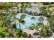 Aerial view of the resort-style community pool surrounded by lush landscaping and palm trees at 11125 Mcdermott Ct, Englewood, FL 34223