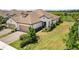 Sprawling single-story home with a tile roof, two-car garage, and lush green landscaping at 11125 Mcdermott Ct, Englewood, FL 34223