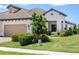 Inviting single-story home showcasing a tile roof, two-car garage, and meticulously maintained landscaping at 11125 Mcdermott Ct, Englewood, FL 34223