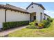 Elegant single-story home featuring a tile roof, two-car garage, and colorful landscaping at 11125 Mcdermott Ct, Englewood, FL 34223