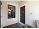 Welcoming front entry with a decorative wreath and a charming welcome mat at 11125 Mcdermott Ct, Englewood, FL 34223
