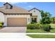 Charming single-story home featuring a tile roof, two-car garage, and a beautifully landscaped front yard at 11125 Mcdermott Ct, Englewood, FL 34223