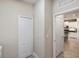Hallway leading into the kitchen, featuring tile floors and a pantry at 11125 Mcdermott Ct, Englewood, FL 34223