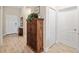 Entryway featuring wood-look tile flooring, a decorative wooden cabinet, and a view into the adjacent rooms creating an open feel at 11125 Mcdermott Ct, Englewood, FL 34223