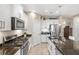 Well-equipped kitchen featuring granite counters, stainless steel appliances, and a large island with seating for casual dining at 11125 Mcdermott Ct, Englewood, FL 34223