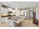 Modern kitchen with white cabinets, stainless steel appliances, granite countertops, and an island with barstool seating at 11125 Mcdermott Ct, Englewood, FL 34223