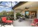 Relaxing screened lanai with comfortable seating and open access to the home's interior, perfect for enjoying the outdoors at 11125 Mcdermott Ct, Englewood, FL 34223