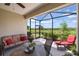 Inviting screened-in patio with cozy seating area overlooking the lush greenery, ideal for relaxation and outdoor enjoyment at 11125 Mcdermott Ct, Englewood, FL 34223