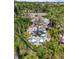 A community tiki bar surrounded by palm trees and lush landscaping. Numerous tables and chairs are available for residents at 11125 Mcdermott Ct, Englewood, FL 34223