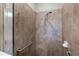 Tiled walk-in shower featuring a grab bar and adjustable shower head at 11125 Mcdermott Ct, Englewood, FL 34223