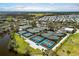 A birdseye view reveals pristine tennis and pickleball courts, framed by lush landscaping at 11125 Mcdermott Ct, Englewood, FL 34223
