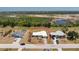 Home exterior shot with surrounding neighborhood homes and green space in the background at 113 Annapolis Ln, Rotonda West, FL 33947